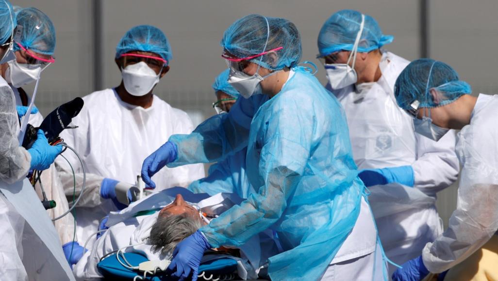 فريق طبي فرنسي يتعامل مع مصاب بكورونا (رويترز)