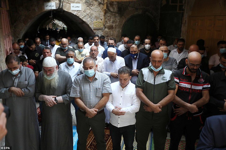 WEST BANK: Palestinians pray in the street after being prevented from entering the Ibrahimi mosque due to overcrowding