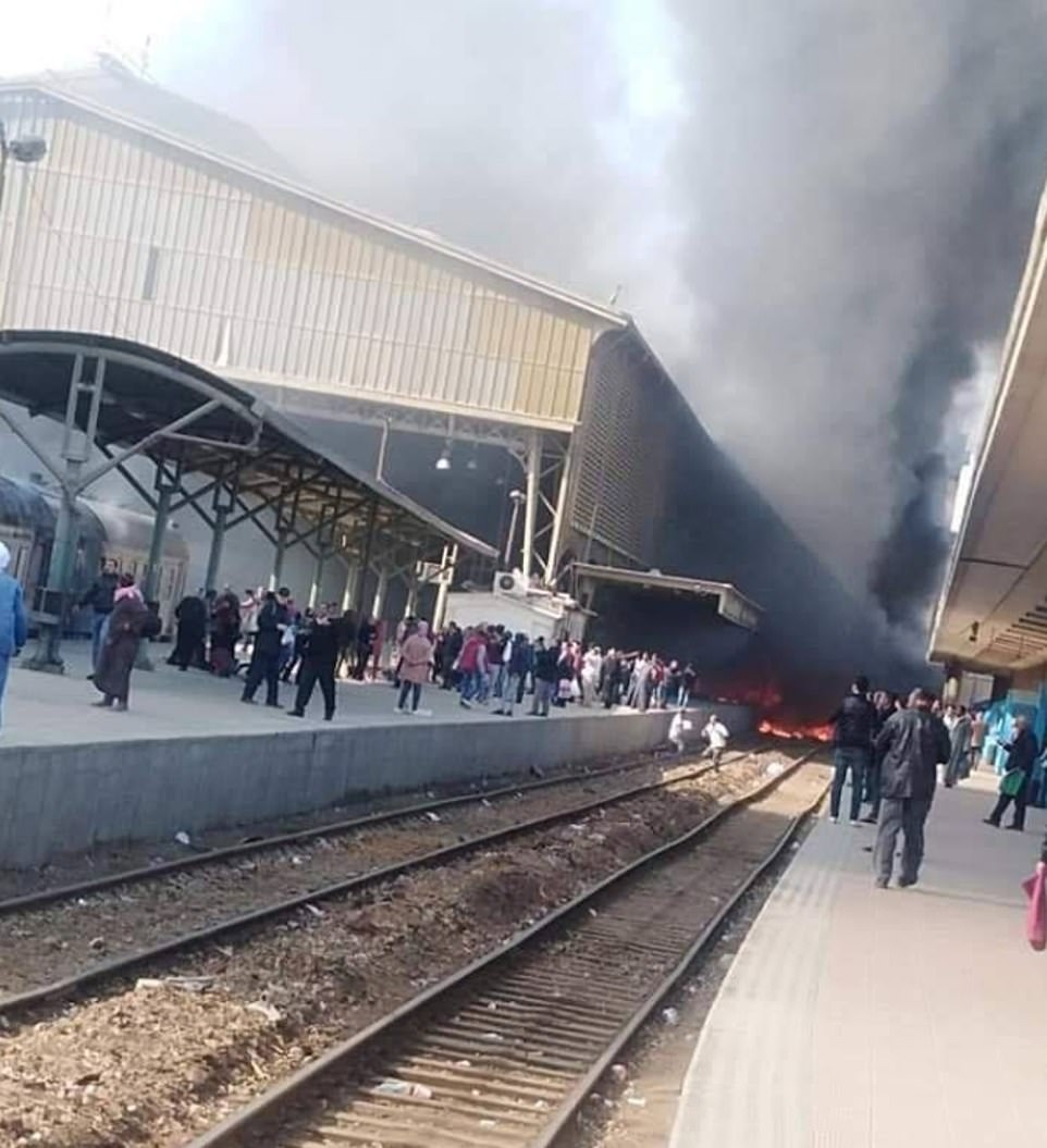 Flames cover the train tracks and one of the platforms at Ramses station in Cairo as people flee for their lives down the track 