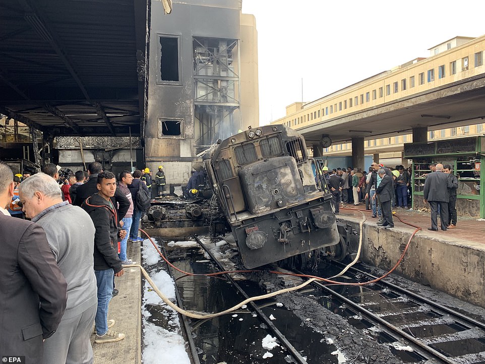 Pictures of the train show it has come off the rails after hitting a buffer at the end of the tracks with heavy fire damage to the surrounding buildings