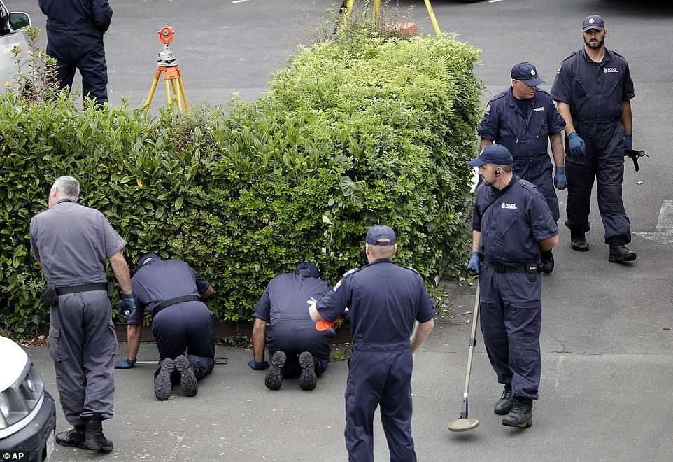 The investigation is ongoing as police are seen scouring the shrubbery of a motel near the Al Noor Mosque in Christchurch