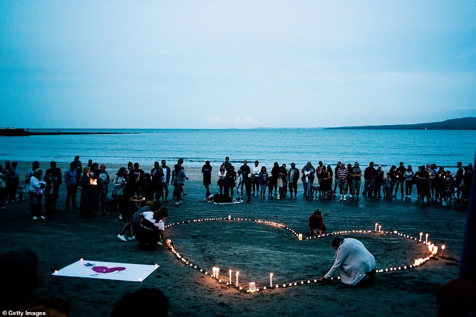 Crowds of mourners have gathered for a vigil in memory of the victims on Takapuna Beach in Auckland