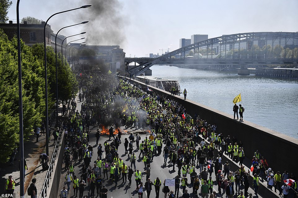 Protesters from the 'Gilets Jaunes' movement march through Paris's streets during the 'Act XXIII' demonstration