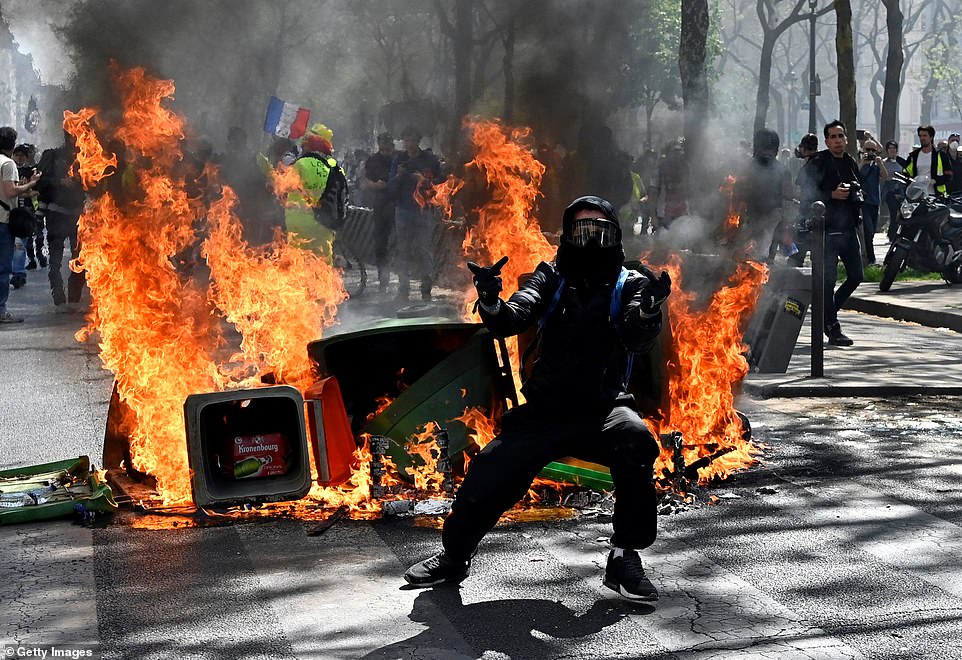 Yellow vest protesters burn rubbish bins during the 'Act XXIII' demonstration near Place de la Republique today in Paris
