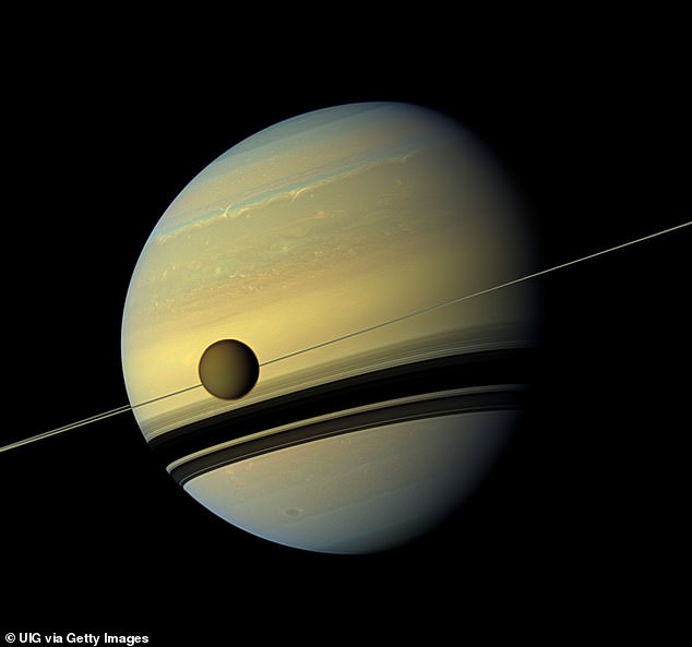Cassini helped to gather information on Titan (shown in front of Saturn) having orbited Saturn 13 times throughout its life