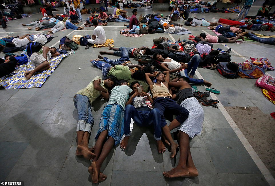 No service: Stranded passengers rest inside a railway station after trains between Kolkata and Odisha were cancelled ahead of Cyclone Fani