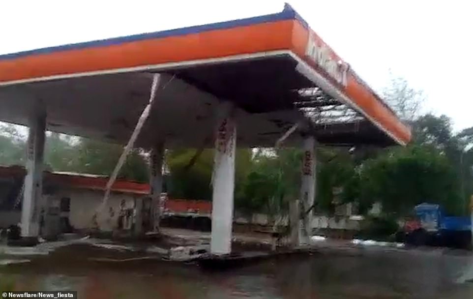 Ravaged: A petrol station is seen with debris on the ground after the 130mph cyclone struck India's east coast on Friday