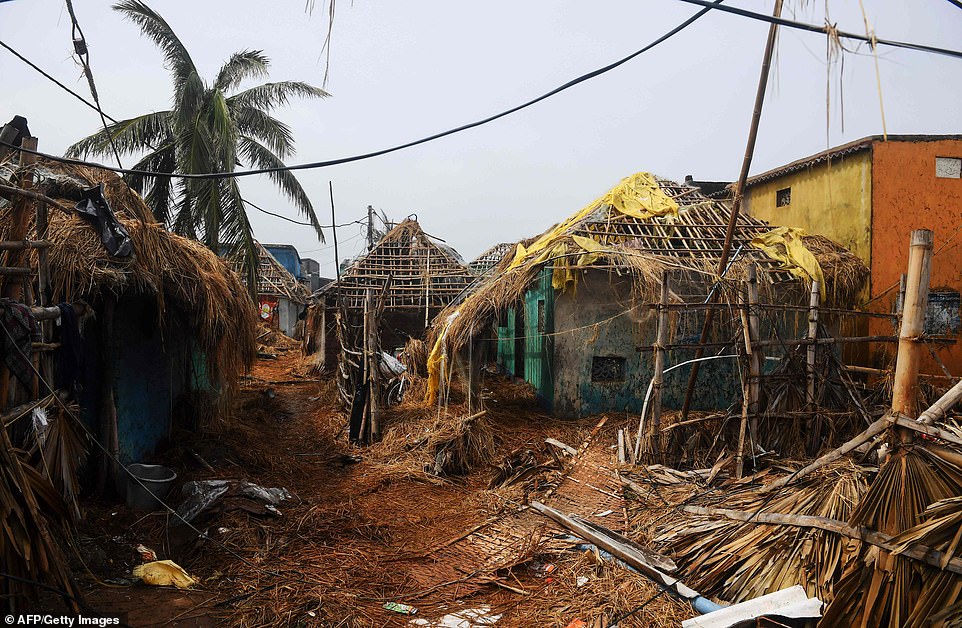Damaged homes are pictured near the seafront in Puri in the eastern Indian state of Odisha today following the Cyclone