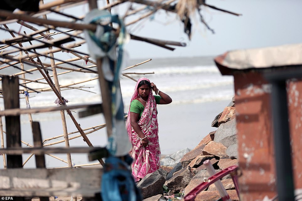 An Indian woman reconstructs a food shop after Cyclone Fani hit the town of Digha in West Midnapore district, West Bengal, India, today
