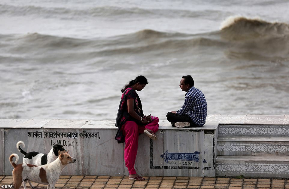 People sit on the shore after Cyclone Fani hit Digha in West Midnapore district, West Bengal, India, today