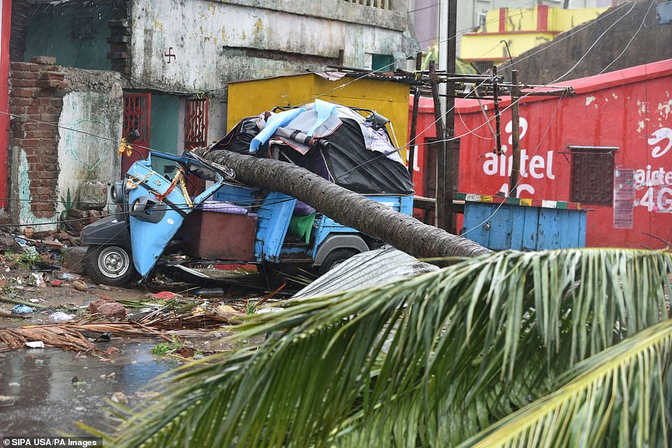 A fallen tree and damaged vehicle seen after the onset of cyclone Fani on May 3, 2019 in Puri, India