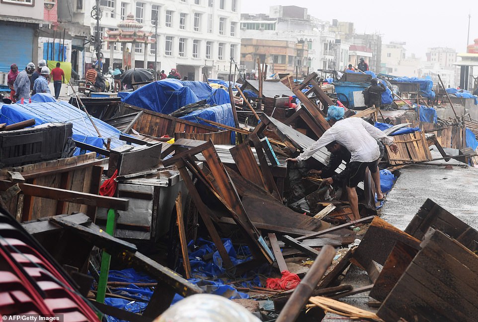 Indian residents inspect damages on street stalls at a promenade after Cyclone Fani landfall in Puri in the eastern Indian state of Odisha on May 3