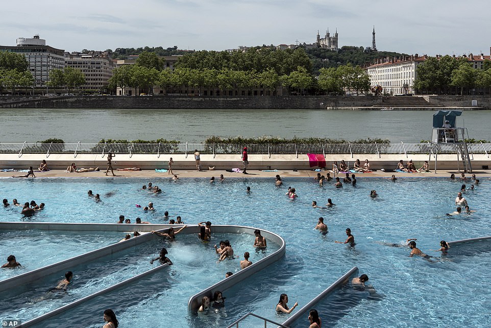 People visit a swimming pool in the center of Lyon, central France