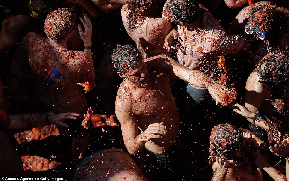 One man takes a second to take in the tomato-throwing festival, in a the middle of a heaving crowd of participants in Bunol