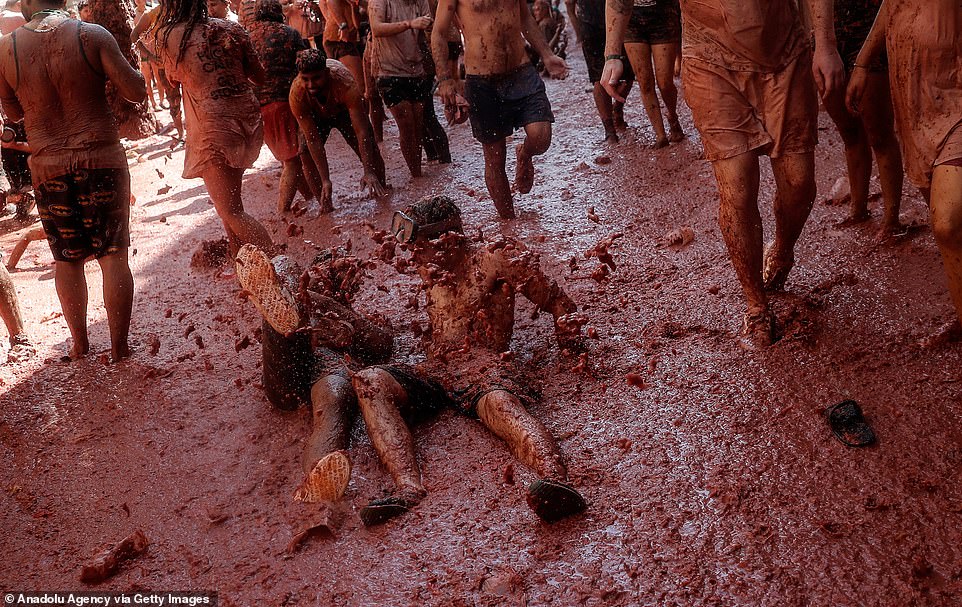 Every inch of the ground looked to be covered in tomato pulp during the today's festivals, with crews later hosing down the streets