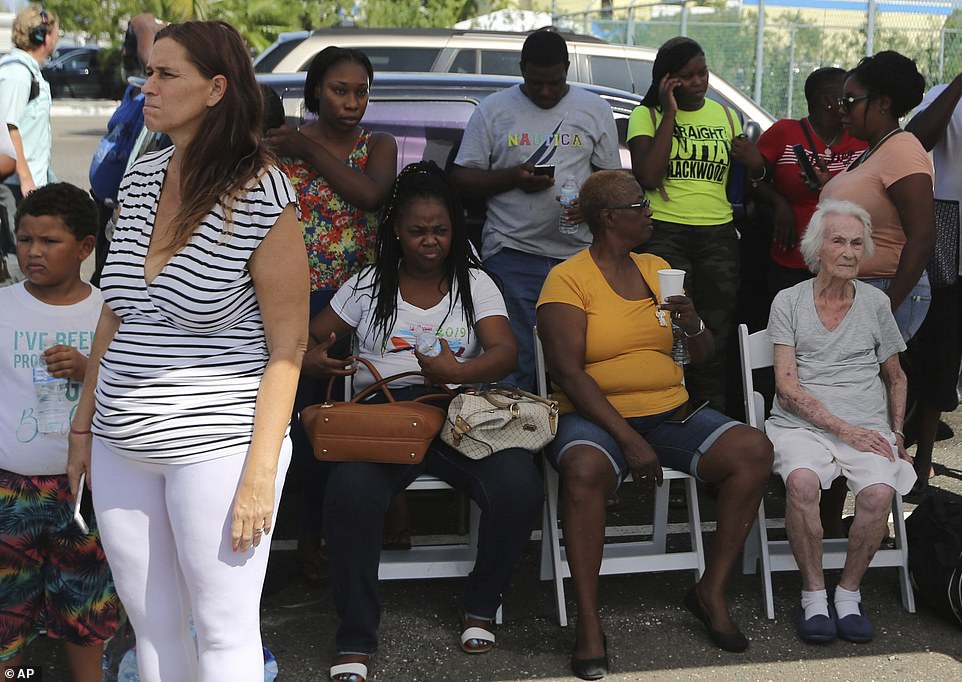 Residents wait for assistance at the airport in Nassau, Bahamas, on Thursday, after they were rescued from Abaco