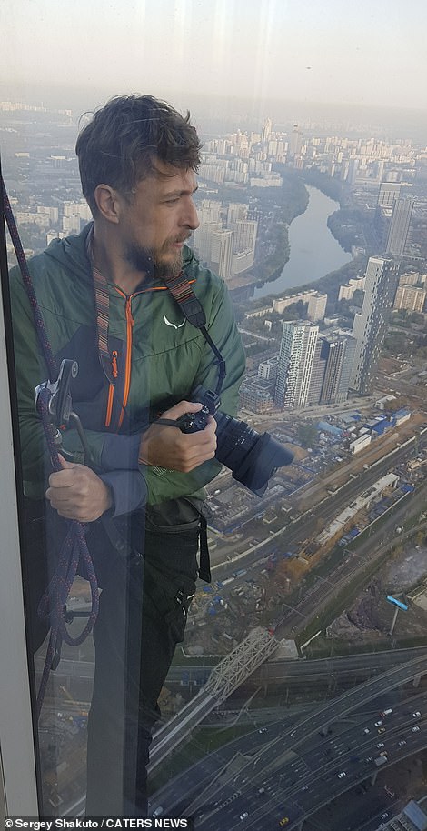 Shakuto, an action sports photographer, takes pictures while hundreds of feet above the ground in Moscow