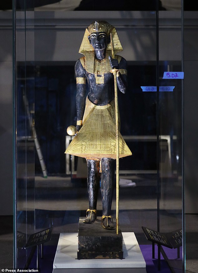 A wooden guardian statue of the Ka of the King wearing the Nemes headcloth, shown in Paris's Grande Halle de la Villette