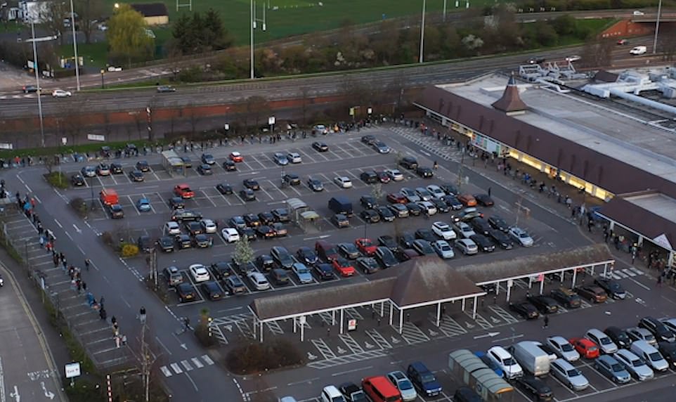 Hundreds of shoppers were seen queueing around a packed Tesco carpark waiting for early morning deliveries today