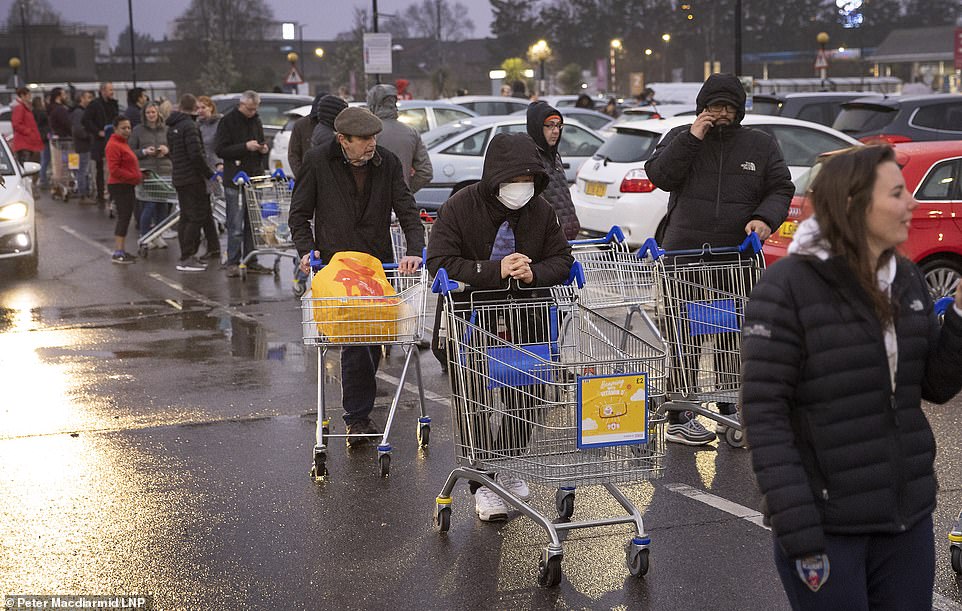 Hundreds of panicked shoppers were seen queueing around a packed carpark outside a Tesco in New Malden this morning