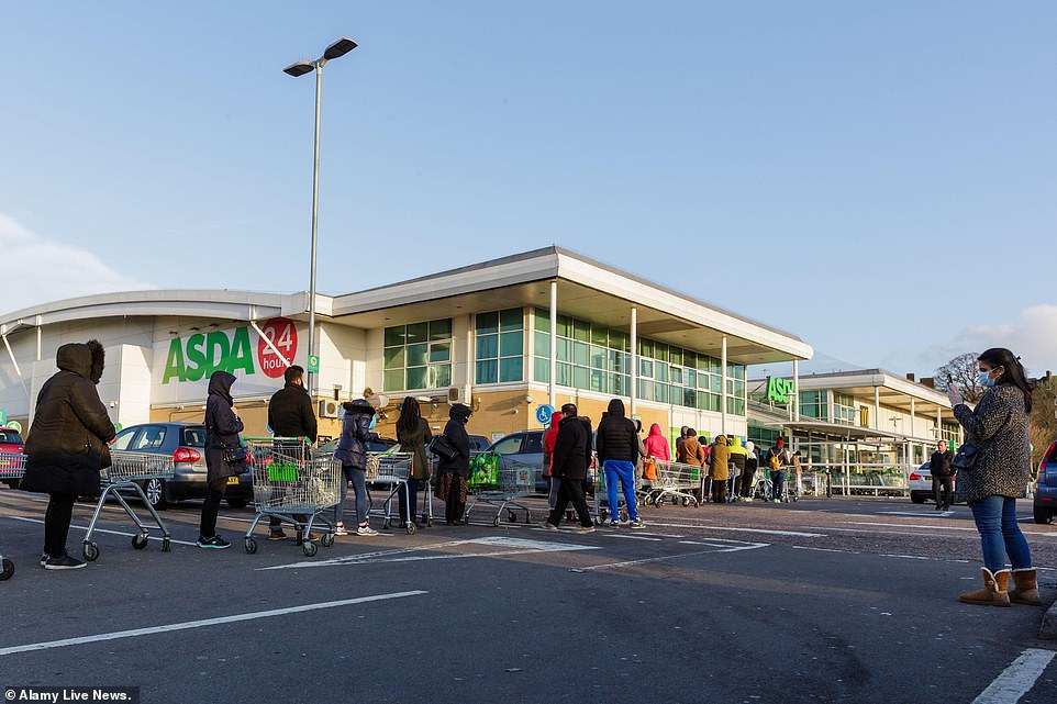 More indignant shoppers continue to queue up outside an Asda in Middlesex despite warnings from the government that such behaviour will leave vulnerable customers unable to buy essentials