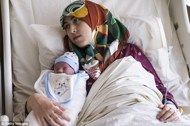 The pair fled their native country three years ago because of the devastating civil war and found out they were pregnant in the same week. Pictured, Gade Birinci with her child