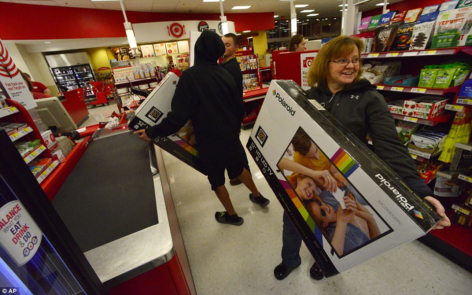 NEW HAMPSHIRE: Shoppers in Target had more room to themselves and snagged cut-price TVs on Thursday night. Above, Jane Sousie and her son with their matching TVs in a store in Keene 
