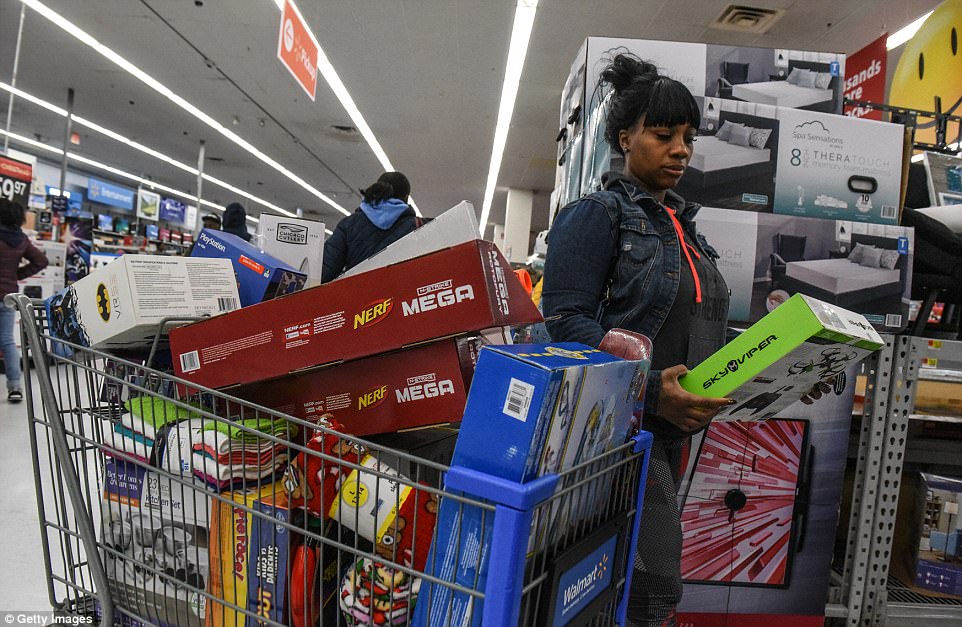 NEW YORK STATE: At the Green Acres Mall in Valley Stream, New York, a woman piles more goods into a trolley full of items 