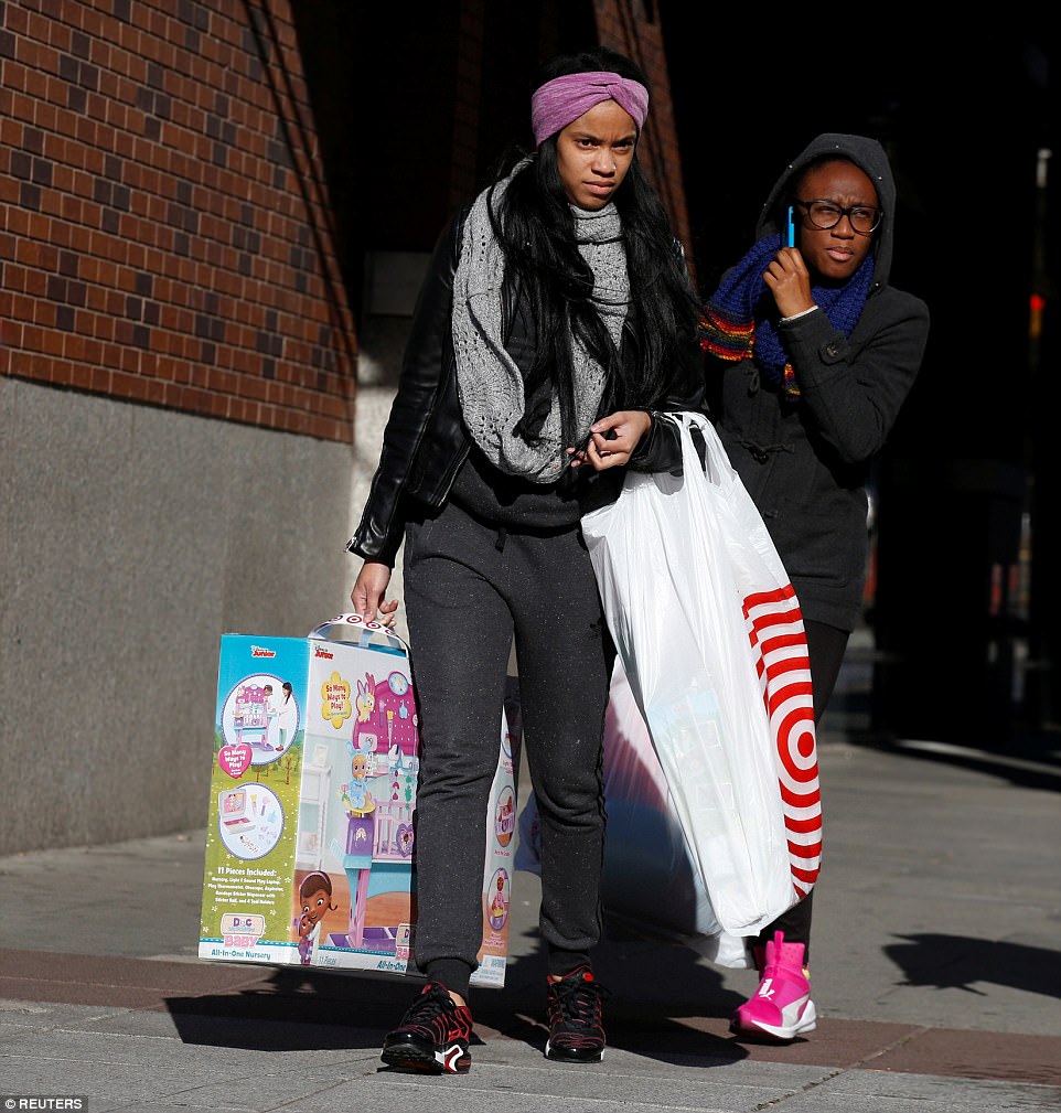 BROOKLYN: In Brooklyn, New York, a young woman carries a large Target bag and children's toy down the street 