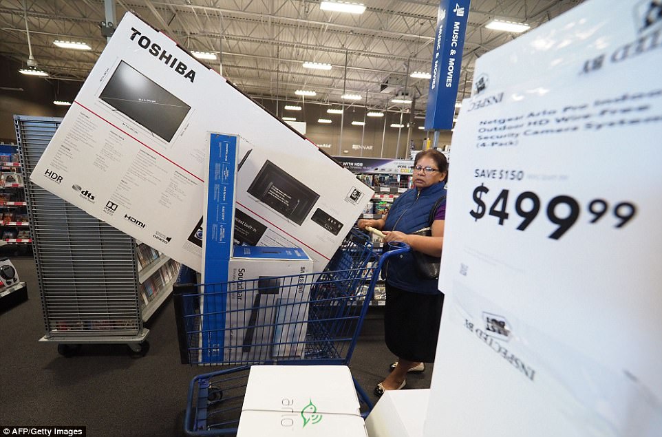 CALIFORNIA: In Burbank, a woman pushes an enormous television and sound bank through Best Buy