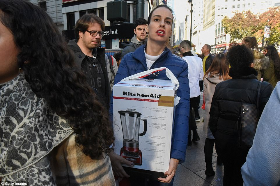 MANHATTAN: A woman makes her way through Herald Square with a KitchenAid blender 