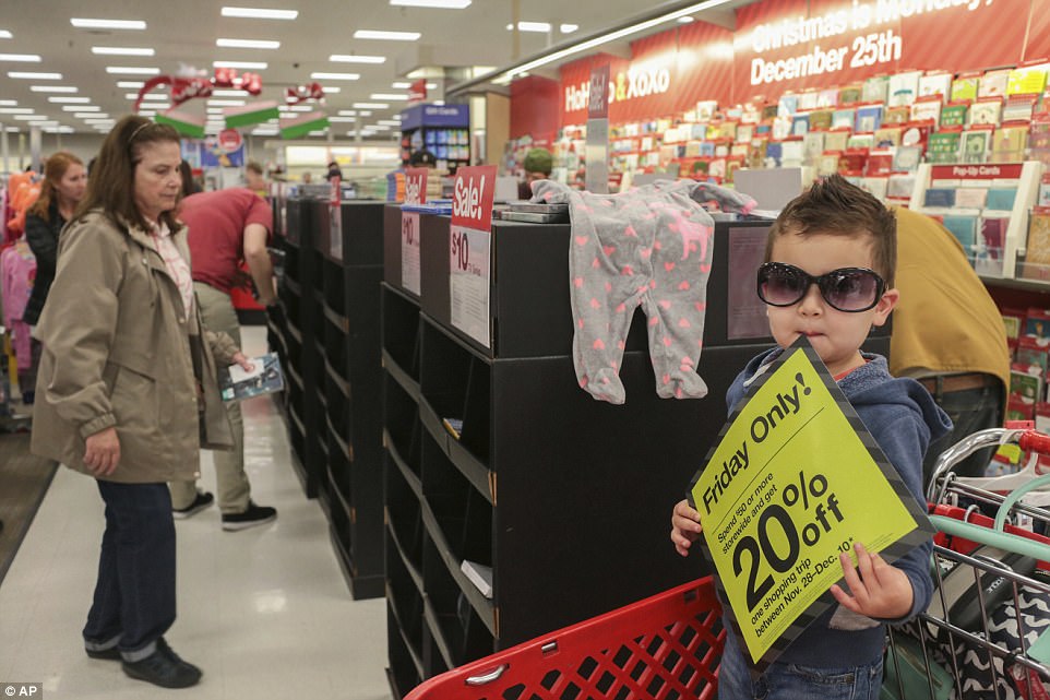 IDAHO: Three-year-old Tyler Green entertains himself as his family shops in Target in Idaho Falls 
