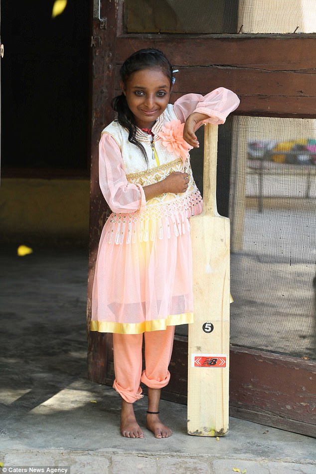 An Indian girl who was described as being as small as a mouse when she was born beats the odds to reach her 18th birthday - despite only being as tall as a cricket bat. Mandeep Batwal, divides opinions in her Punjabi village in northern India, seen as either adorable or cursed