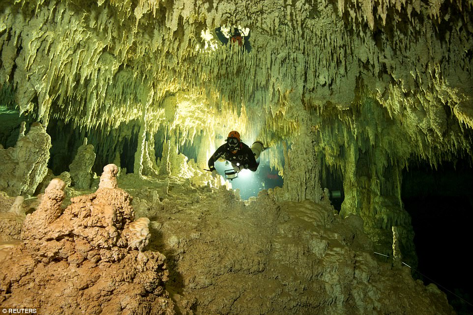 A scuba diver measures the length of the Sac Actun cave in Mexico, which is part of the Dos Ojos cavern system
