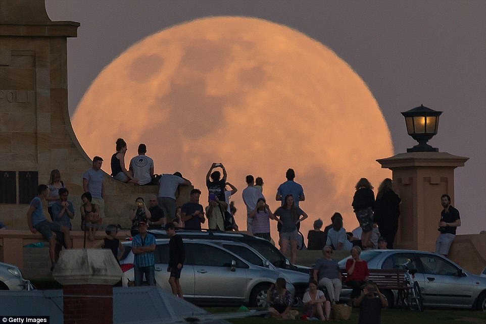 The alignment of the sun, moon and Earth will last one hour and 16 minutes and will be visible before dawn on today across North America, Alaska, Hawaii and Canada. Crowds look on as the super moon rises behind the Fremantle War Memorial at Monument Hill in Australia on November 14, 2016