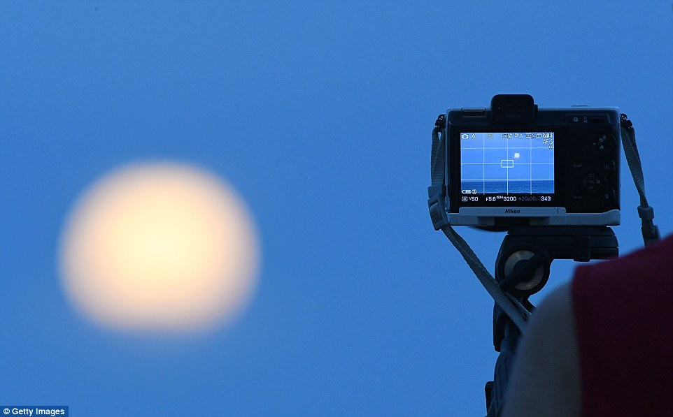 Keen photographers capture the moon rising from the Marine Parade Beach in New Zealand. For those in the Middle East, Asia, eastern Russia, Australia and New Zealand, the 'super blue blood moon' can be seen during moonrise this evening
