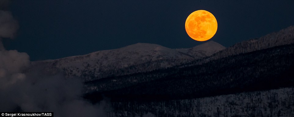 A red moon rises over hills near the city of Yuzhno-Sakhalinsk on Sakhalin Island in Russia's Far East ahead of the appearance of the rare super blue blood moon. The UK, Europe and Africa will miss out on seeing the red tinge on the super moon as they'll be unable to see the lunar eclipse