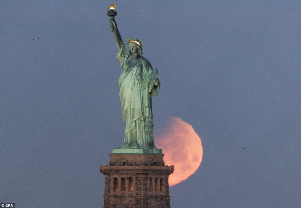 The super blue blood moon is pictured behind the Statue of Liberty in New York. The event began at 10:51am UTC (10:51 GMT, 05:51 ET) with the full lunar eclipse starting at 12:51 am UTC (12:51 GMT, 07:51 ET) and reaching its maximum at 1.29pm UTC (1.29pm GMT, 08:29am ET)