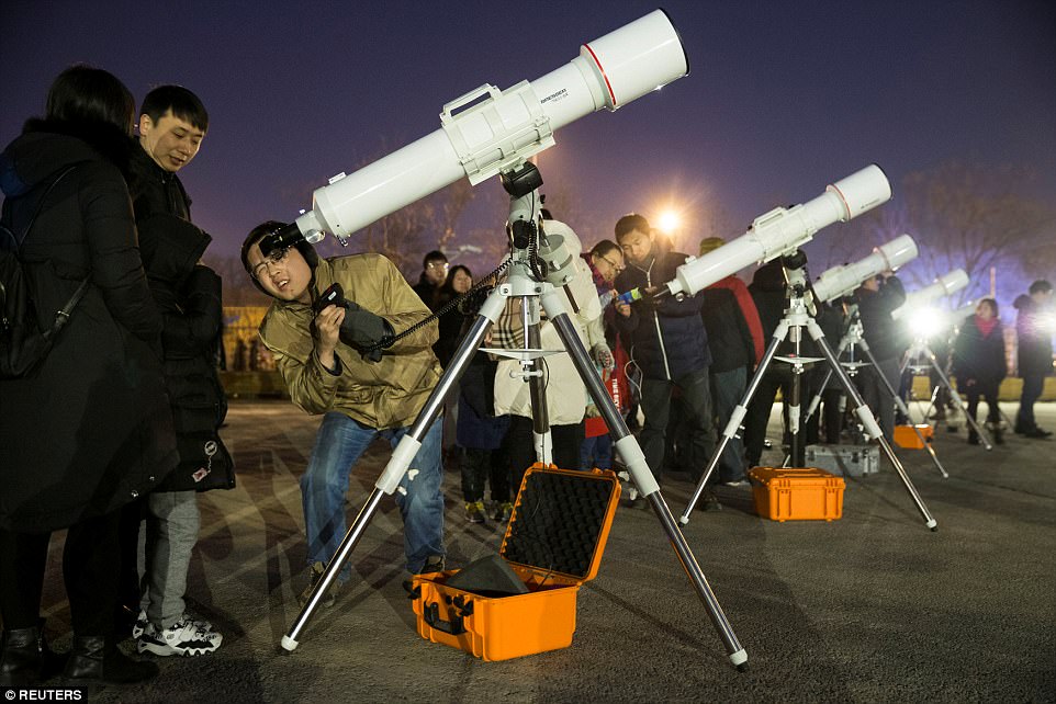 Skywatchers gather at Beijing Planetarium to watch a "super blood blue moon" eclipse with telescopes, in Beijing, China January 31, 2018. China Daily via REUTERS ATTENTION EDITORS - THIS IMAGE WAS PROVIDED BY A THIRD PARTY. CHINA OUT.