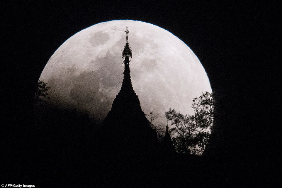  The moon rises over a pagoda in Kumal, some 105 kms away from Mandalay City