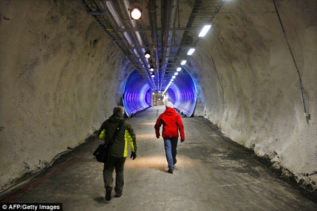 The vault is aimed at providing humans with a 'Noah's Ark' of food in the event of a global disaster. Pictured, people walk into the Svalbard Global Seed Vault, which is now ten years old