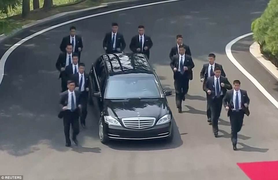 As Kim's car left the first round of talks for lunch, it was protected by 12 suited bodyguards who formed a ring around the vehicle while jogging to keep up