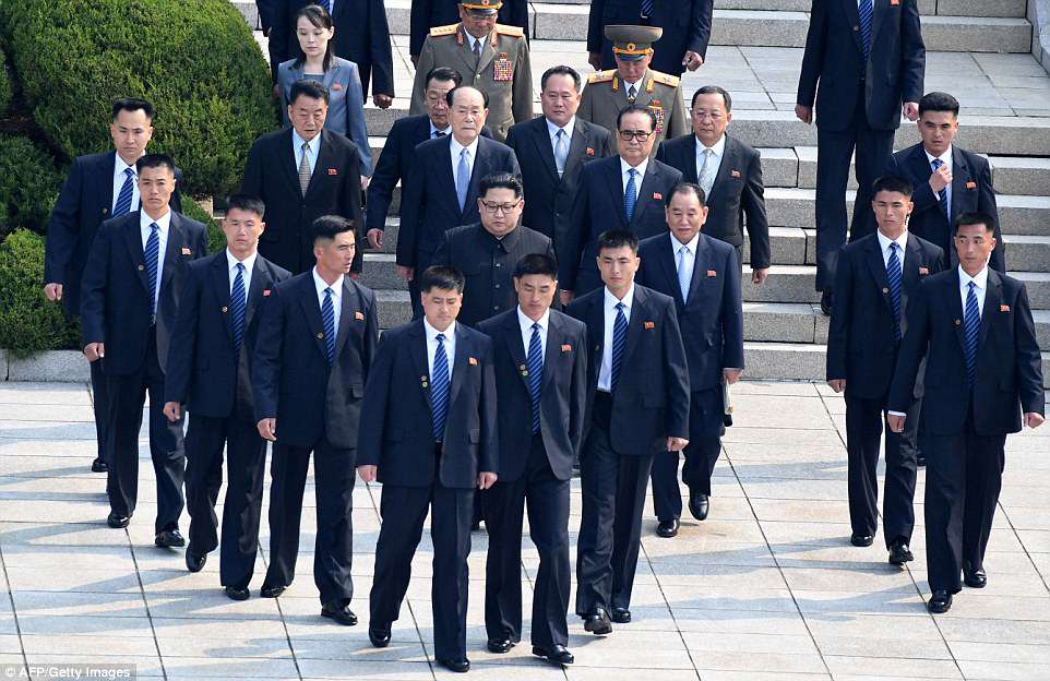 Kim Jong Un (middle, centre) is escorted by North Korean bodyguards as he walks from the North to the Military Demarcation Line