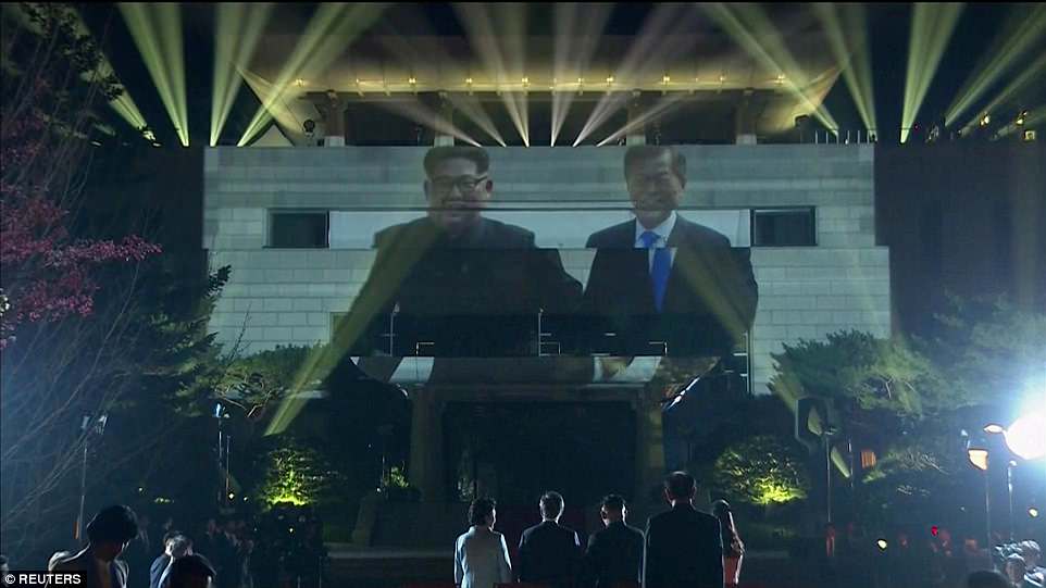 Photos of the summit were projected onto a massive screen installed in front of the building where Kim and Moon met