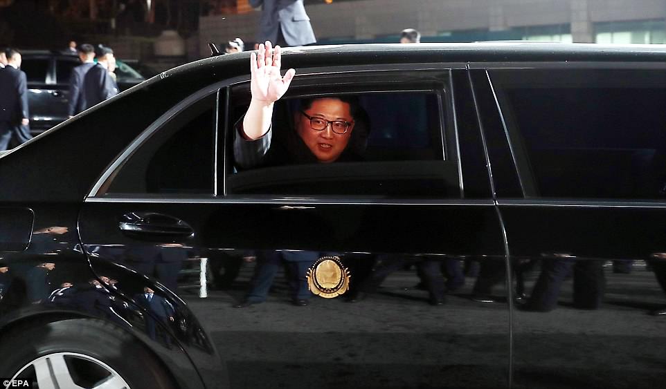 Kim Jong-un waves from his car as he bids farewell to South Korean President Moon Jae-in at the Peace House building at the end of their summit