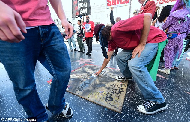 A board covers the spot where Trump's star usually sits in the Hollywood Walk of Fame, as the Hollywood Historic Trust prepares to replace the damaged landmark