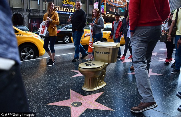 A gold-colored toilet, shown here when it was placed by Trump's star in May 2016, was part of a larger art installation, created in reference to the Guggenheim offering to loan the president a golden toilet after turning down a request for a specific piece of Van Gogh art