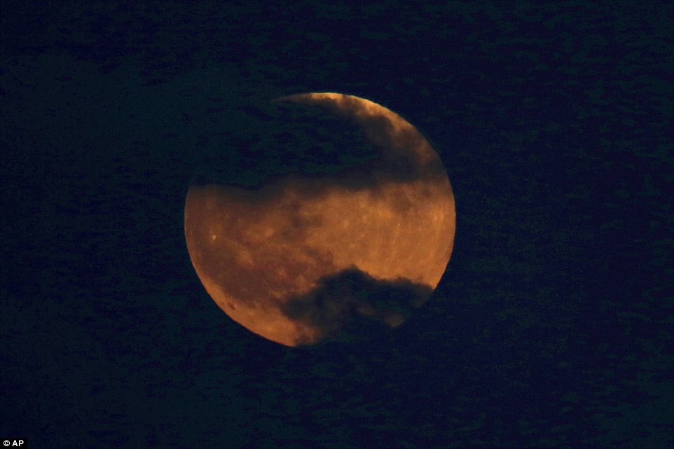 A Blood Moon rises over Tel Aviv, Israel as the rest of the world prepares for the spectacular lunar eclipse themselves