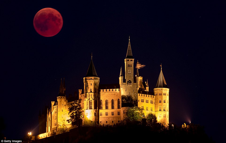 The Blood Moon rises behind The Hohenzollern Castle, the ancestral seat of the Prussian Royal House and of the Hohenzollern Princes, situated at the periphery of the Swabian Alb in Hechingen, Germany