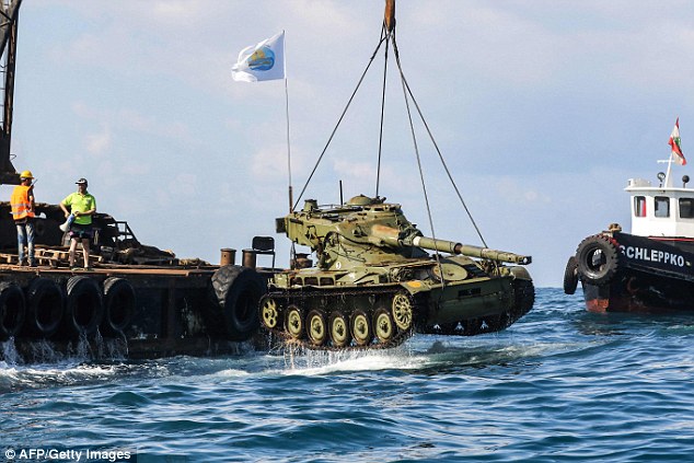 The armoured vehicle is submerged in the water in a move to restore marine life off the Lebanese coast 